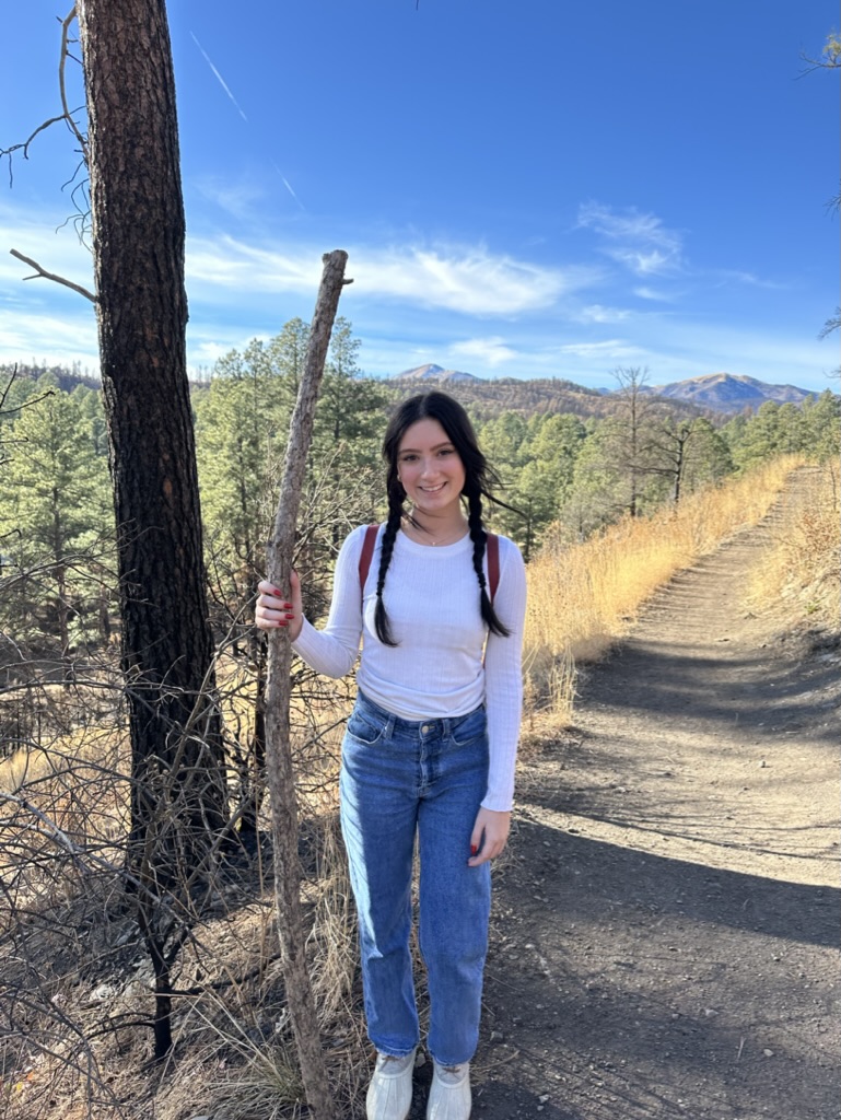 picture of girl smiling in front of mountains